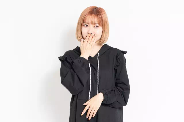 口元を押さえる女性の画像